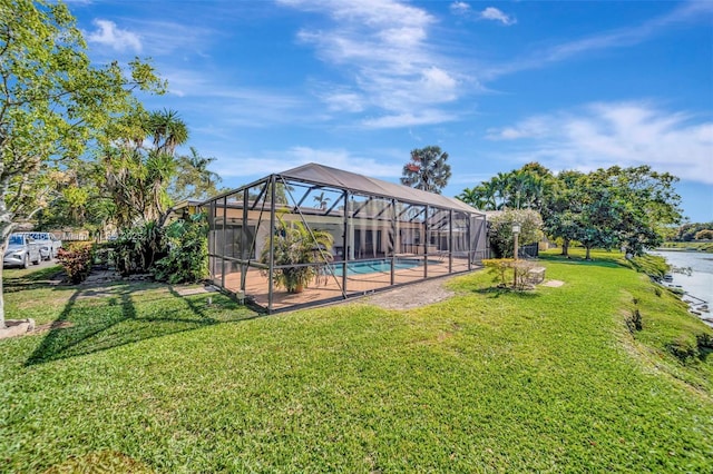 view of yard with glass enclosure and a water view