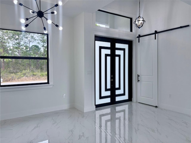 entrance foyer with an inviting chandelier and a barn door