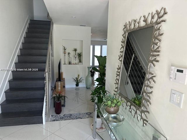 stairway featuring tile patterned floors