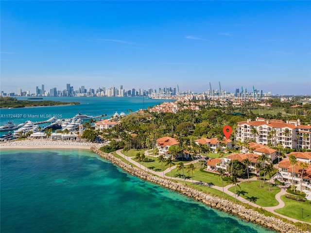 drone / aerial view featuring a water view and a beach view