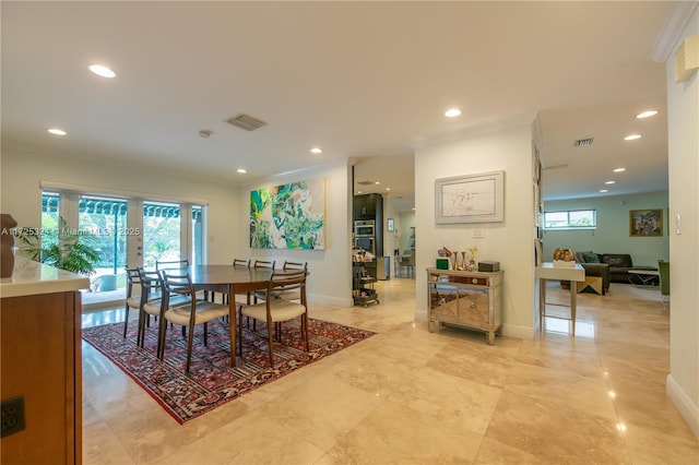 dining space featuring ornamental molding, french doors, and a wealth of natural light