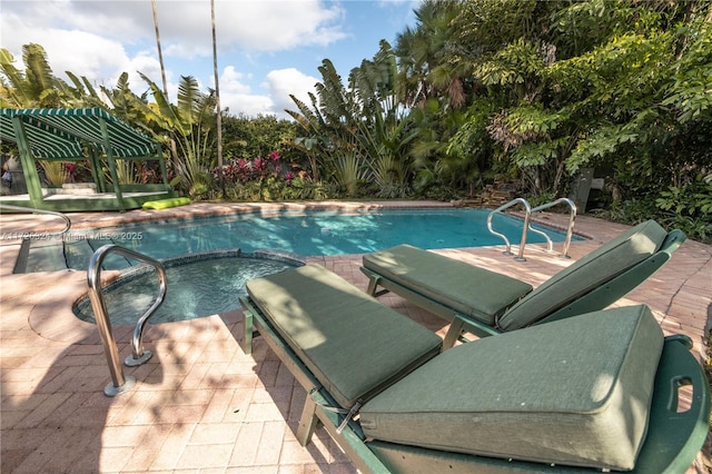 view of swimming pool with an in ground hot tub