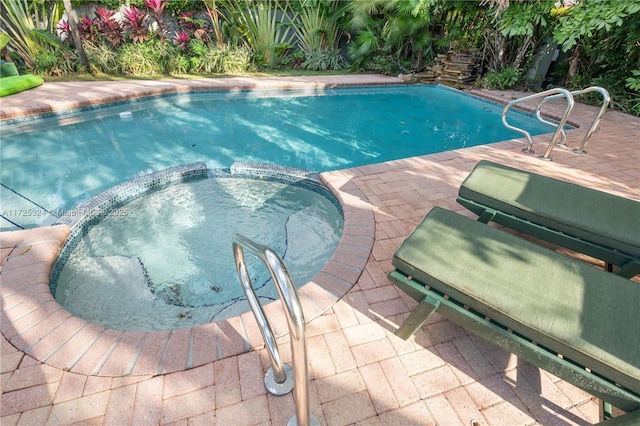 view of swimming pool featuring an in ground hot tub