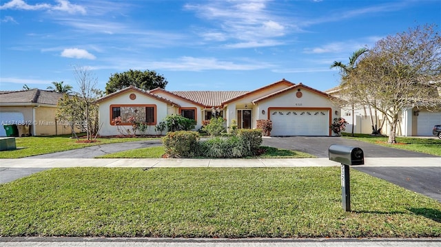 view of front of property with a garage and a front lawn