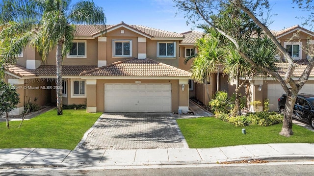 view of front facade with a front yard and a garage