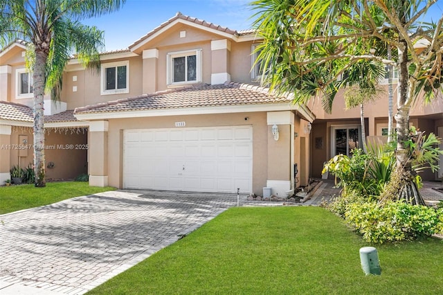 view of front of home with a front yard and a garage