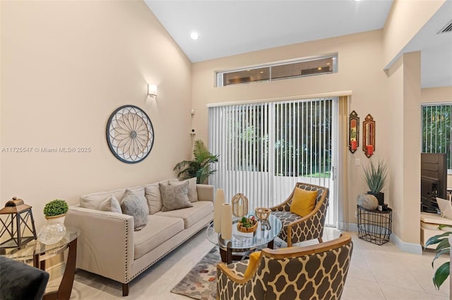 tiled living room featuring high vaulted ceiling