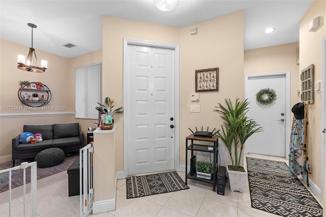 foyer featuring a notable chandelier and light tile patterned flooring