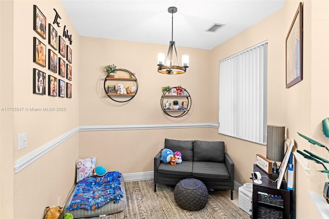 living area featuring a notable chandelier