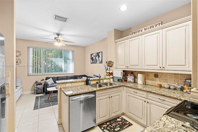 kitchen featuring kitchen peninsula, dishwasher, cream cabinetry, light tile patterned flooring, and sink