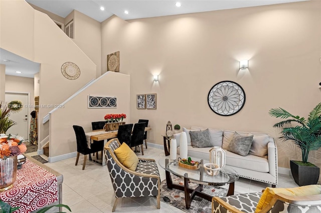 living room with a high ceiling and light tile patterned flooring