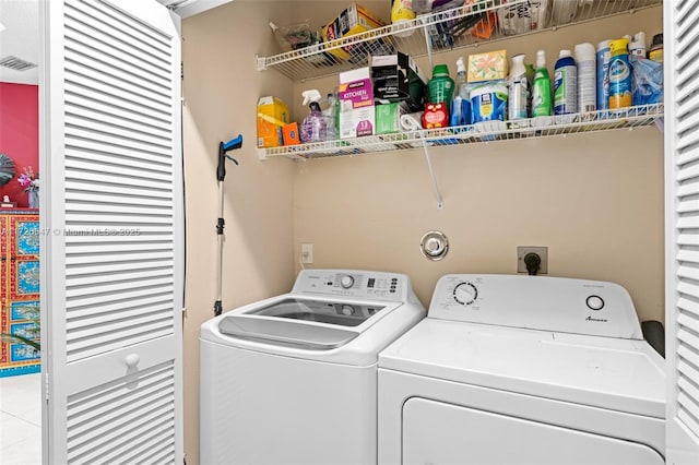 washroom with independent washer and dryer and light tile patterned floors