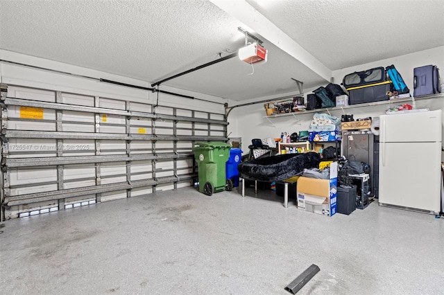 garage with white refrigerator and a garage door opener