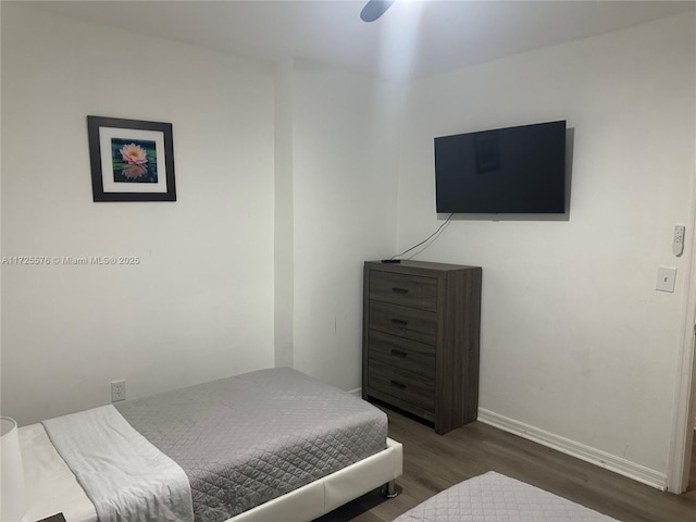 bedroom featuring ceiling fan and dark hardwood / wood-style flooring