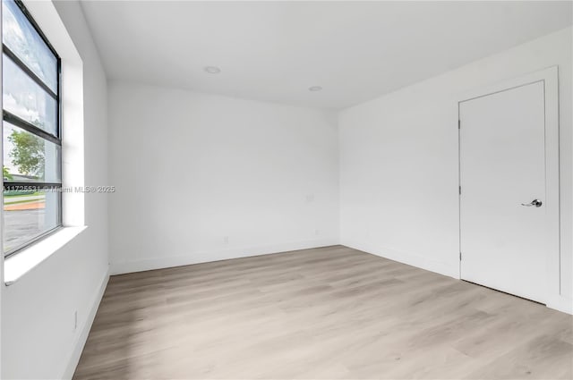 spare room featuring light wood-type flooring