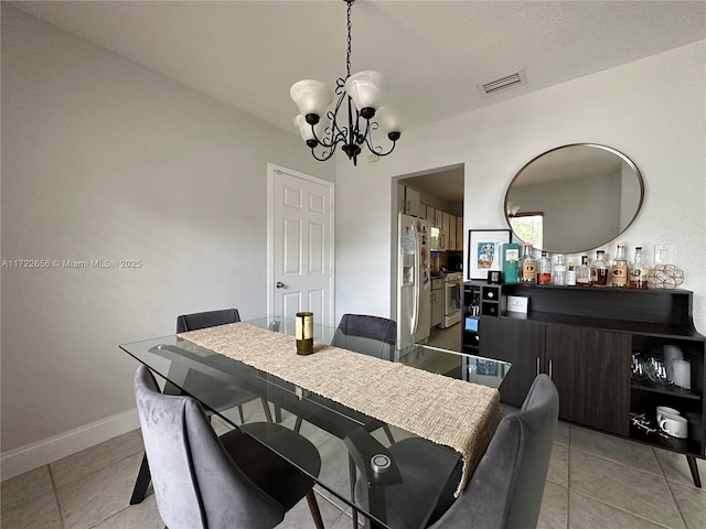 dining room with an inviting chandelier and light tile patterned flooring