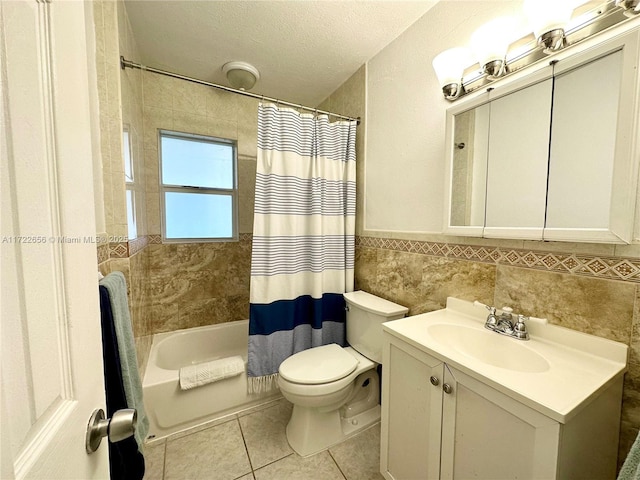 full bathroom featuring a textured ceiling, shower / bathtub combination with curtain, tile walls, toilet, and vanity