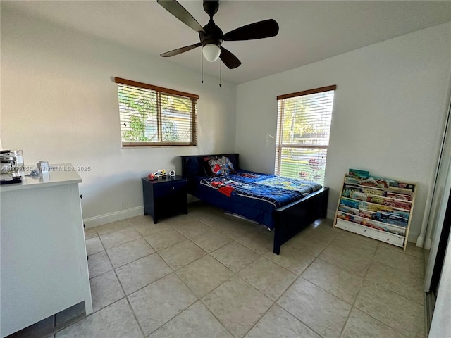 tiled bedroom featuring ceiling fan