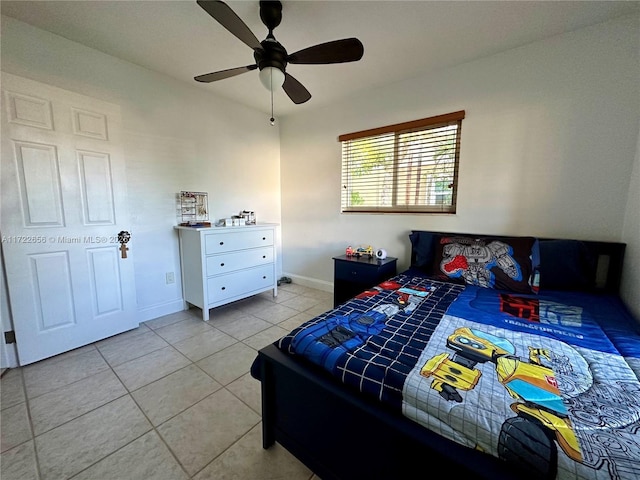 tiled bedroom featuring ceiling fan