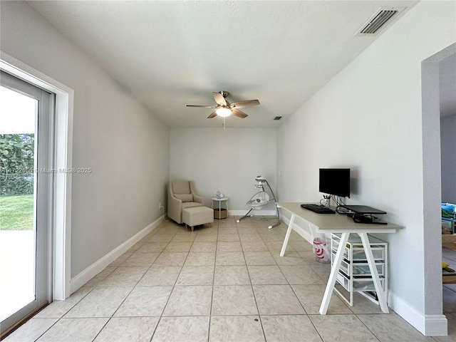 unfurnished office featuring ceiling fan and light tile patterned floors