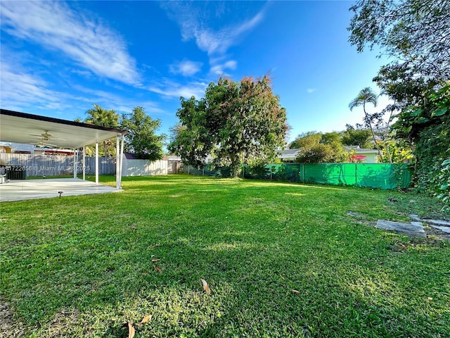 view of yard featuring ceiling fan and a patio area