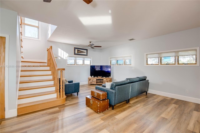 living room featuring ceiling fan and light wood-type flooring