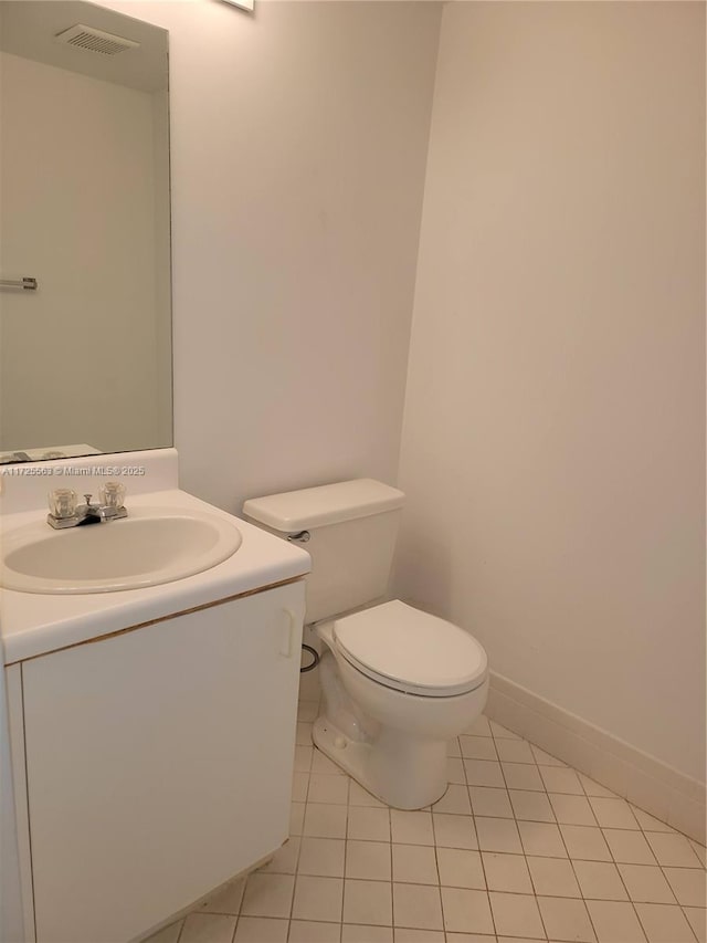 bathroom with tile patterned floors, vanity, and toilet