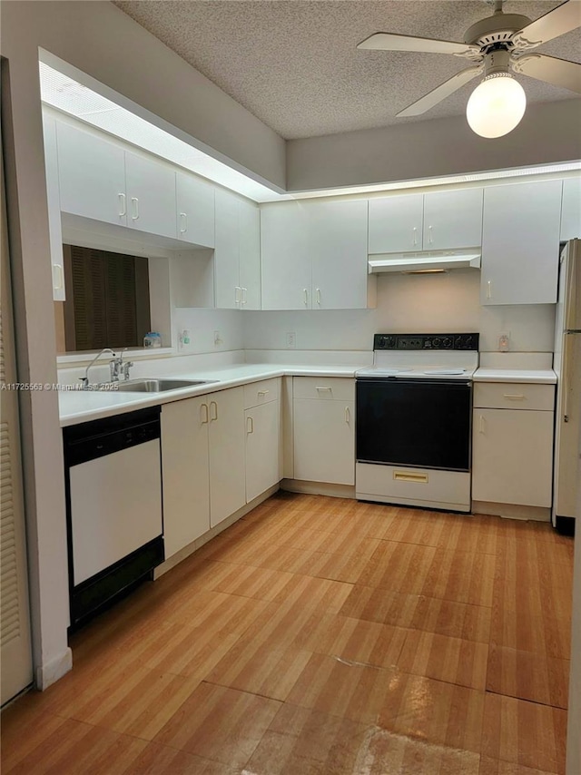 kitchen featuring sink, white cabinetry, a textured ceiling, white appliances, and ceiling fan