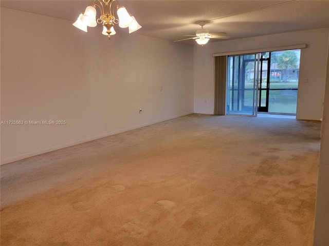 carpeted spare room with a textured ceiling and ceiling fan