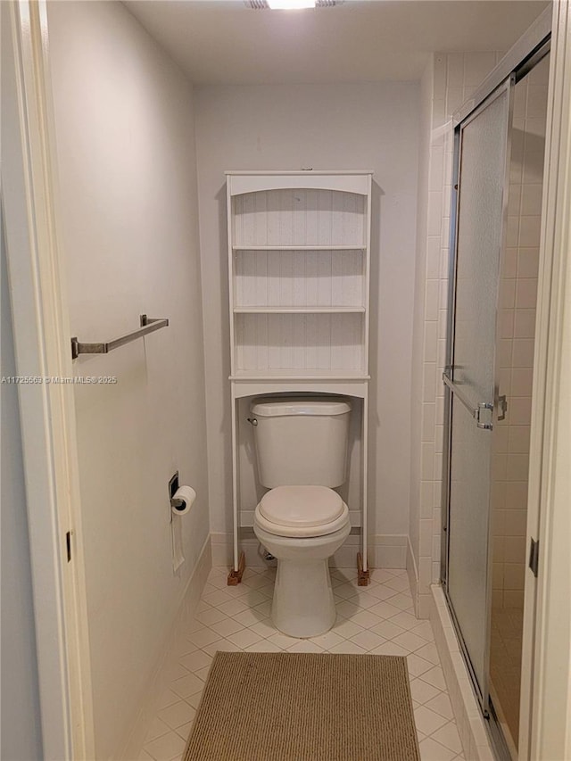 bathroom with walk in shower, tile patterned floors, and toilet