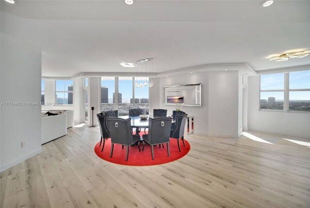 dining area with an inviting chandelier and light hardwood / wood-style floors