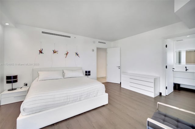 bedroom with hardwood / wood-style floors