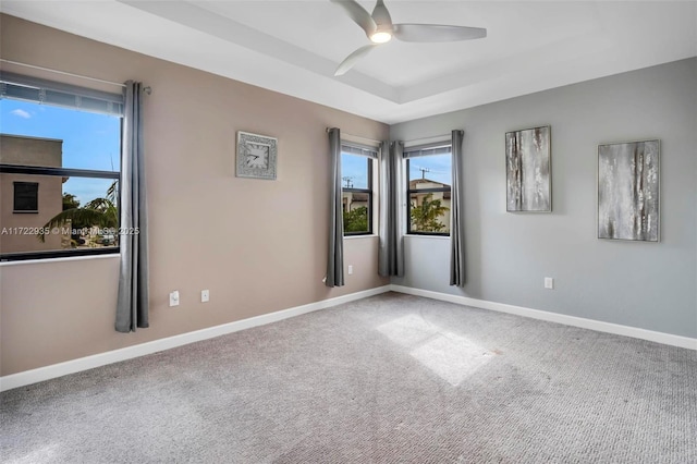 carpeted spare room featuring ceiling fan