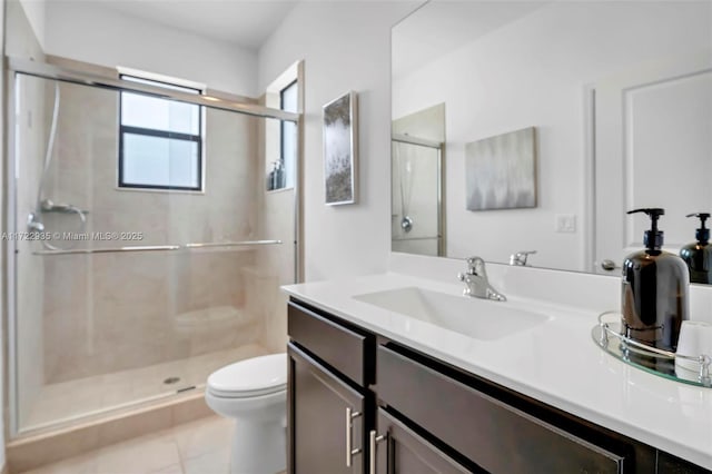 bathroom with toilet, tile patterned flooring, an enclosed shower, and vanity