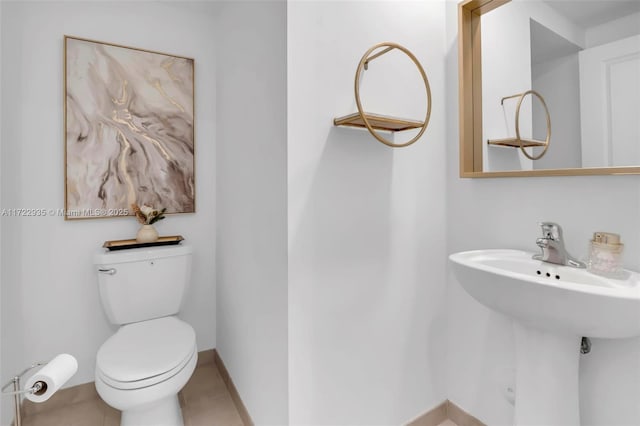 bathroom with toilet and tile patterned floors