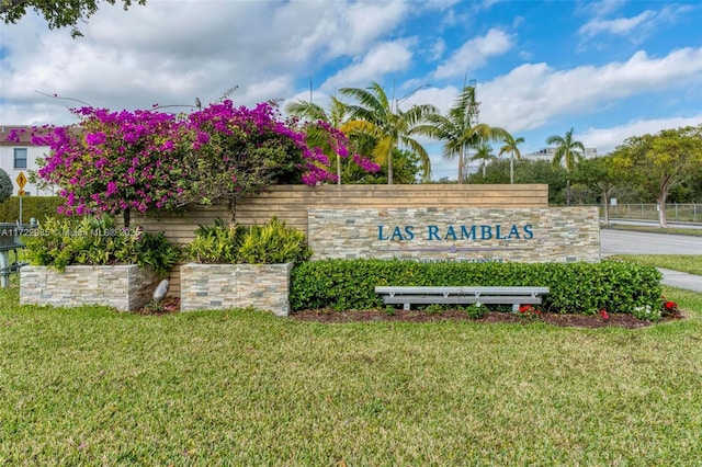 community sign featuring a lawn