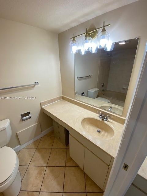 bathroom with vanity, tile patterned flooring, and toilet