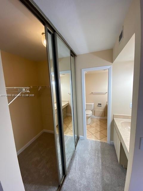 bathroom with vanity, tile patterned flooring, and toilet