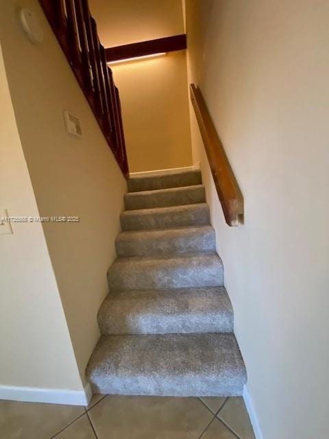 staircase with tile patterned floors