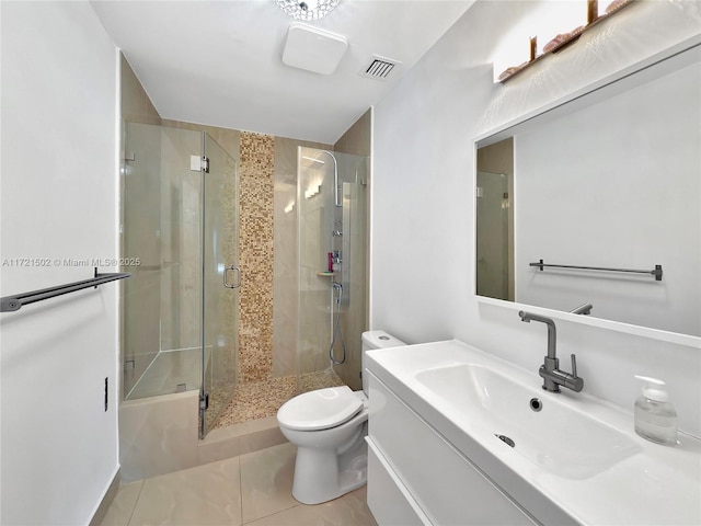 bathroom featuring a shower with door, tile patterned flooring, vanity, and toilet