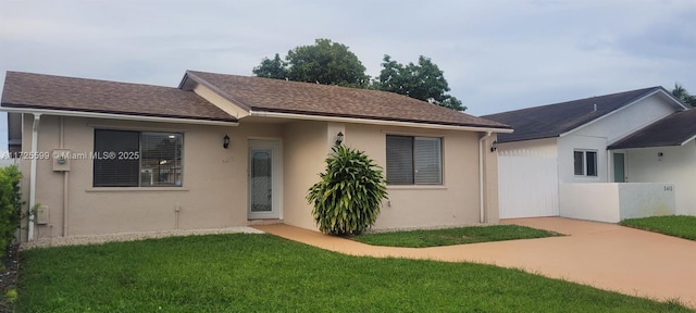 rear view of house featuring a yard