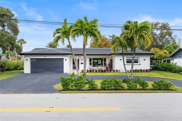 single story home with a front lawn and a garage