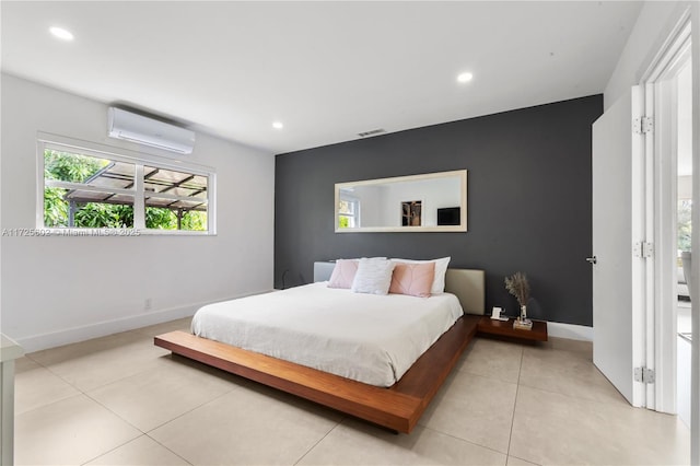 bedroom featuring light tile patterned flooring and a wall unit AC