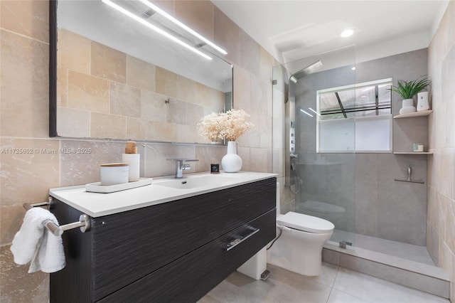 bathroom featuring toilet, tiled shower, tile patterned flooring, tile walls, and vanity