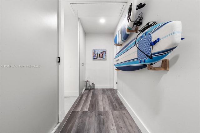 hallway with hardwood / wood-style floors