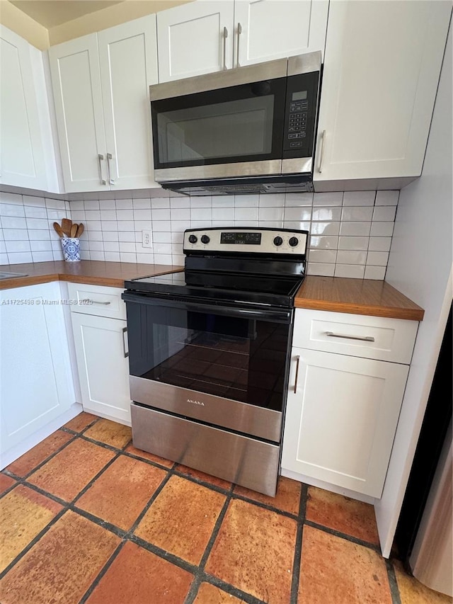 kitchen featuring white cabinets, tasteful backsplash, and appliances with stainless steel finishes