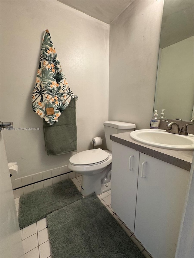 bathroom featuring toilet, tile patterned flooring, and vanity