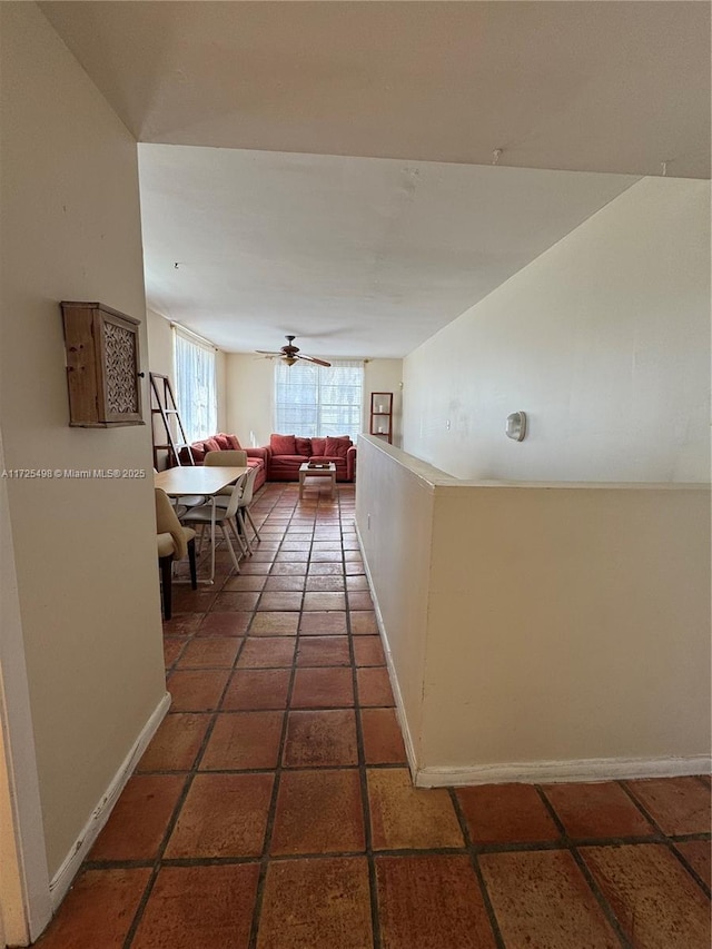 hallway with dark tile patterned flooring