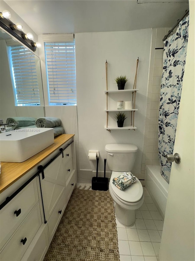 full bathroom with toilet, vanity, tile patterned flooring, and shower / bath combo with shower curtain