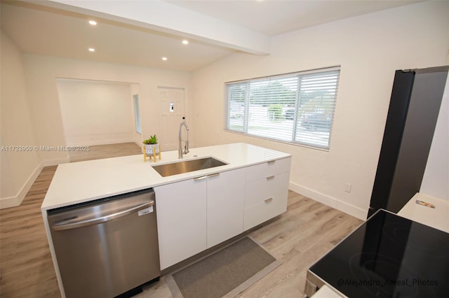 kitchen featuring light hardwood / wood-style flooring, a center island with sink, white cabinetry, appliances with stainless steel finishes, and sink